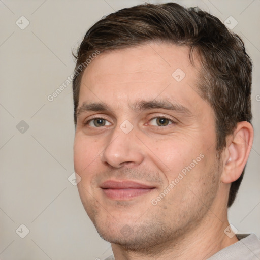 Joyful white adult male with short  brown hair and brown eyes