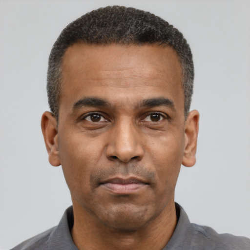 Neutral latino adult male with short  black hair and brown eyes