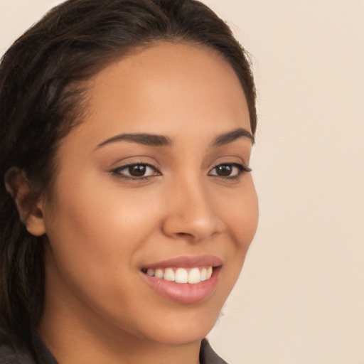 Joyful latino young-adult female with long  brown hair and brown eyes