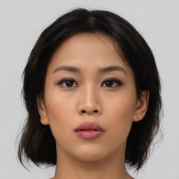 Neutral asian young-adult female with medium  brown hair and brown eyes