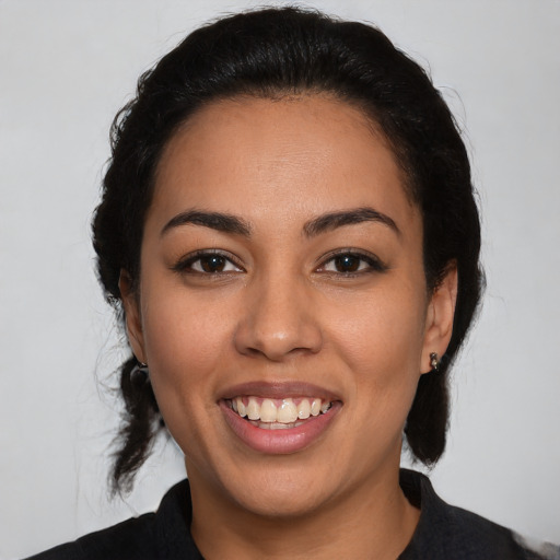 Joyful latino young-adult female with medium  black hair and brown eyes