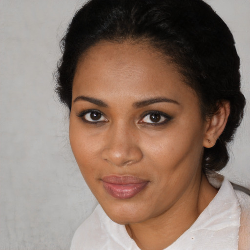 Joyful black adult female with short  black hair and brown eyes