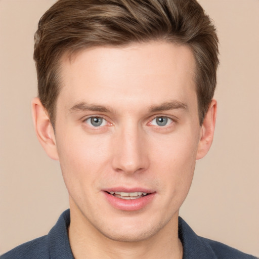 Joyful white young-adult male with short  brown hair and grey eyes