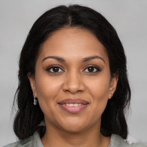 Joyful black young-adult female with medium  black hair and brown eyes