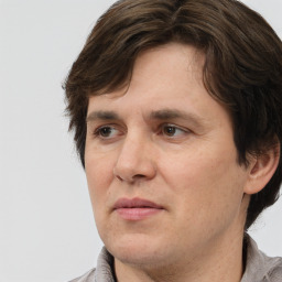 Joyful white adult male with medium  brown hair and brown eyes