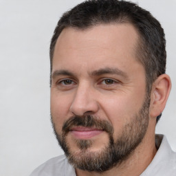 Joyful white adult male with short  brown hair and brown eyes