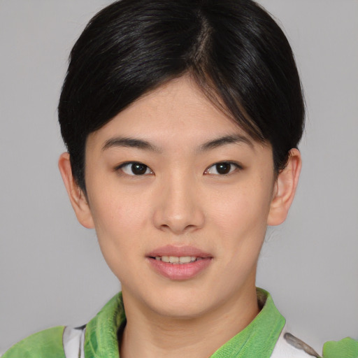 Joyful asian young-adult female with short  brown hair and brown eyes