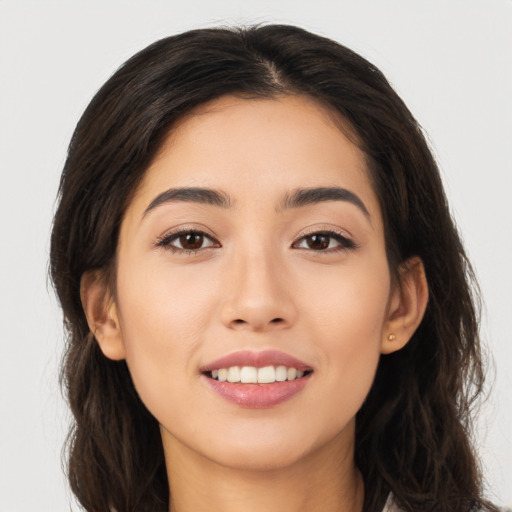 Joyful white young-adult female with long  brown hair and brown eyes