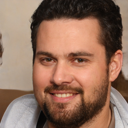 Joyful white adult male with short  brown hair and brown eyes