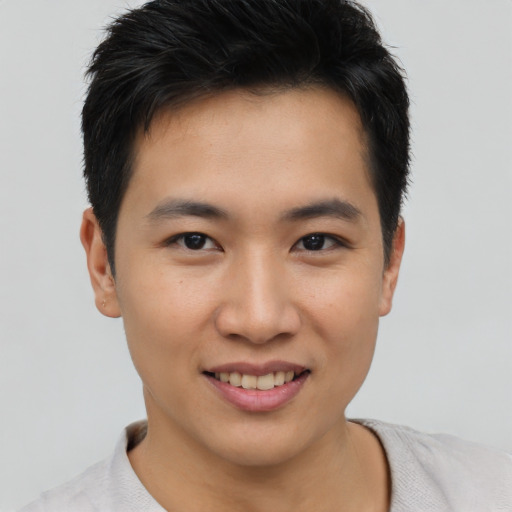 Joyful asian young-adult male with short  black hair and brown eyes
