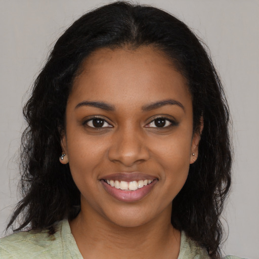 Joyful black young-adult female with medium  black hair and brown eyes