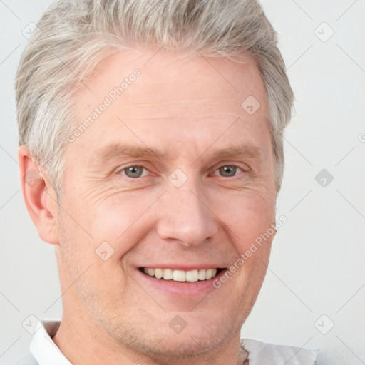 Joyful white adult male with short  brown hair and grey eyes