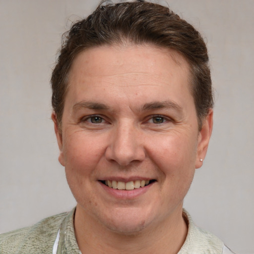 Joyful white adult male with short  brown hair and grey eyes