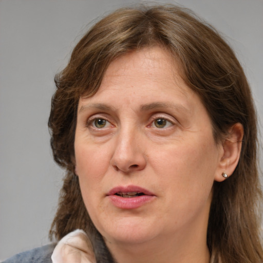 Joyful white adult female with medium  brown hair and grey eyes