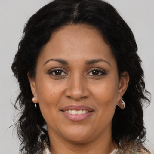 Joyful latino adult female with long  brown hair and brown eyes