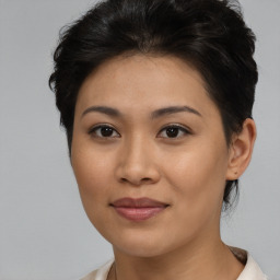 Joyful asian young-adult female with short  brown hair and brown eyes