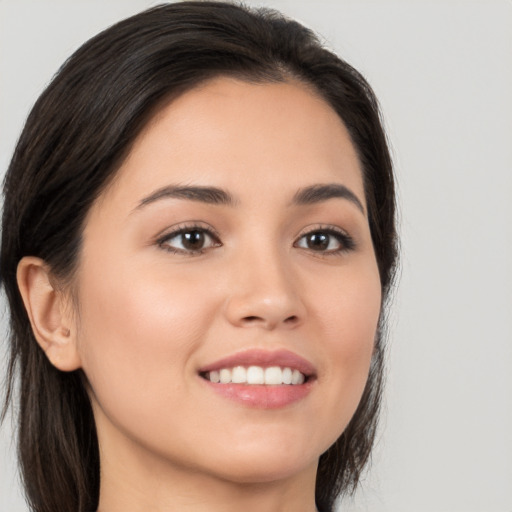 Joyful white young-adult female with long  black hair and brown eyes