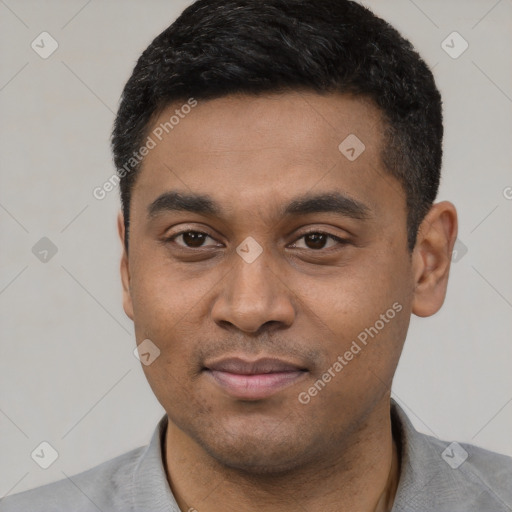 Joyful latino young-adult male with short  black hair and brown eyes