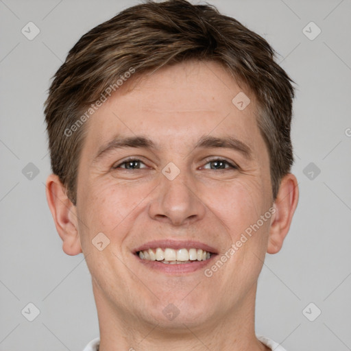 Joyful white adult male with short  brown hair and grey eyes