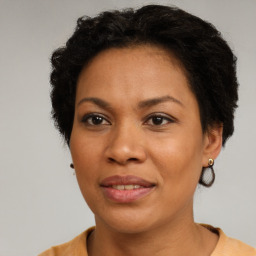 Joyful black adult female with short  brown hair and brown eyes