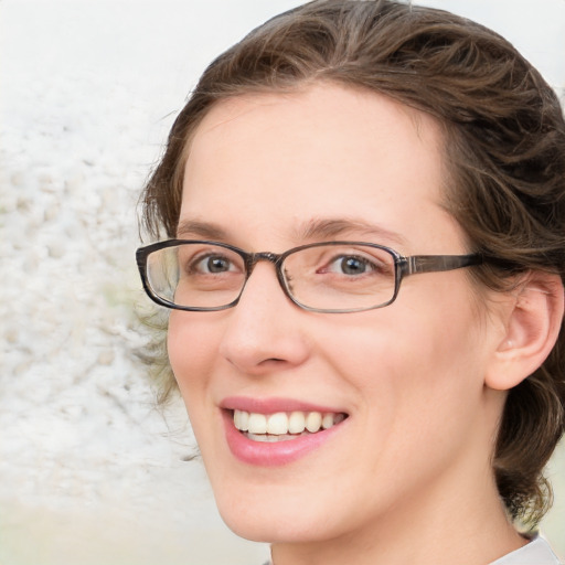 Joyful white adult female with medium  brown hair and blue eyes