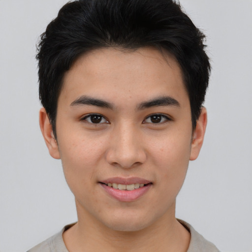 Joyful asian young-adult male with short  brown hair and brown eyes