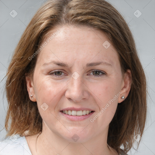 Joyful white adult female with medium  brown hair and grey eyes