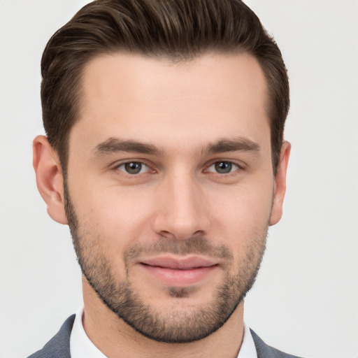 Joyful white young-adult male with short  brown hair and brown eyes