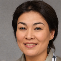 Joyful asian adult female with medium  brown hair and brown eyes