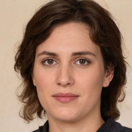 Joyful white young-adult female with medium  brown hair and green eyes