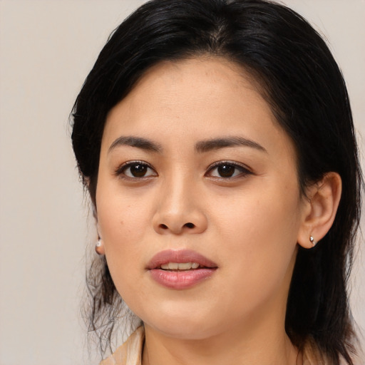 Joyful asian young-adult female with medium  black hair and brown eyes