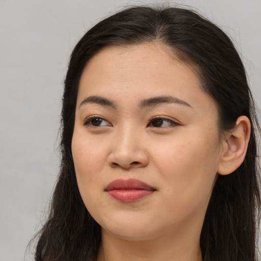 Joyful asian young-adult female with long  brown hair and brown eyes