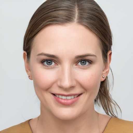 Joyful white young-adult female with medium  brown hair and blue eyes