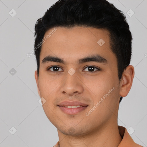 Joyful latino young-adult male with short  black hair and brown eyes