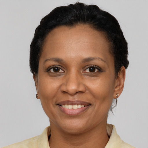 Joyful latino adult female with short  black hair and brown eyes