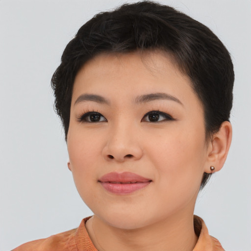 Joyful asian young-adult female with short  brown hair and brown eyes