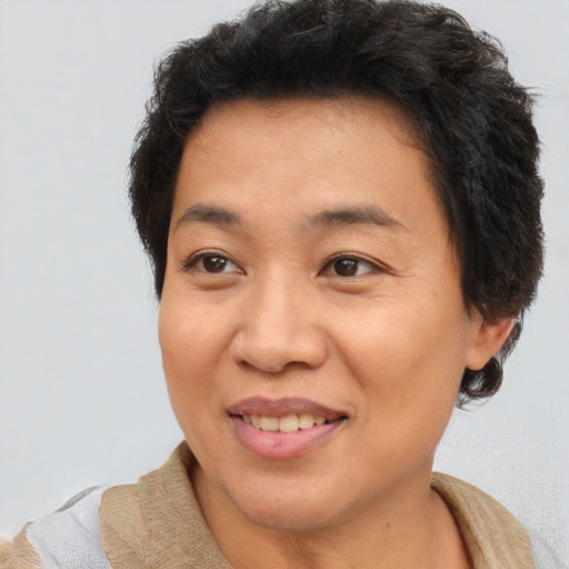 Joyful asian adult female with short  brown hair and brown eyes