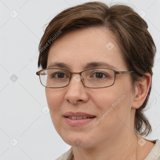 Joyful white adult female with medium  brown hair and brown eyes