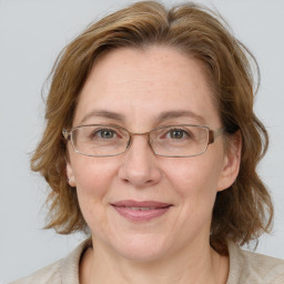 Joyful white adult female with medium  brown hair and blue eyes