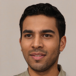 Joyful latino young-adult male with short  black hair and brown eyes