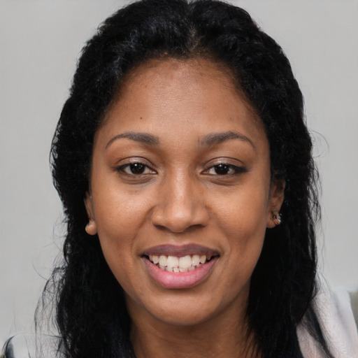 Joyful latino adult female with long  black hair and brown eyes