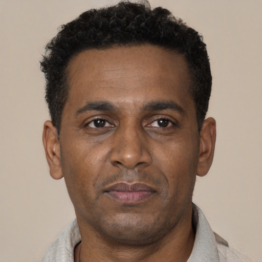 Neutral black adult male with short  black hair and brown eyes
