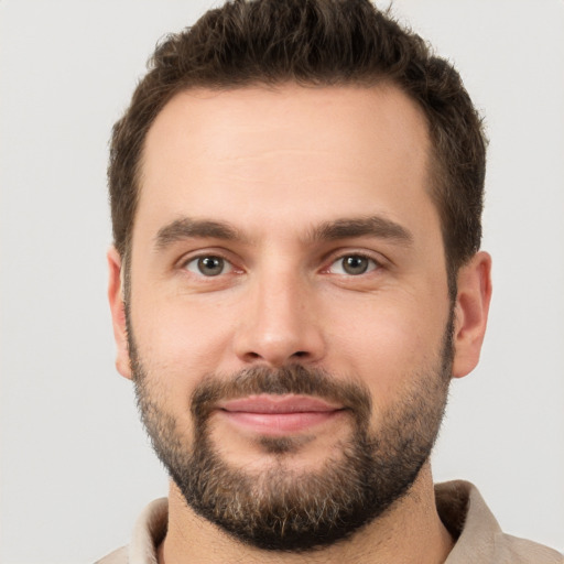 Joyful white young-adult male with short  brown hair and brown eyes