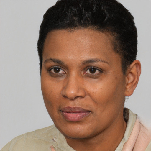 Joyful black young-adult female with short  black hair and brown eyes