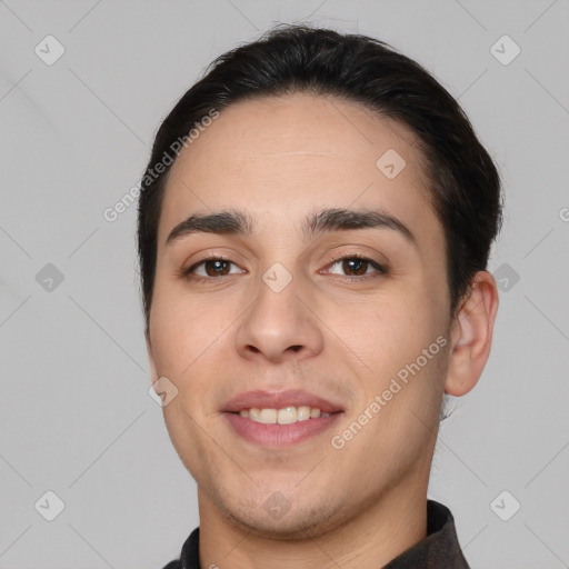 Joyful white young-adult male with short  black hair and brown eyes