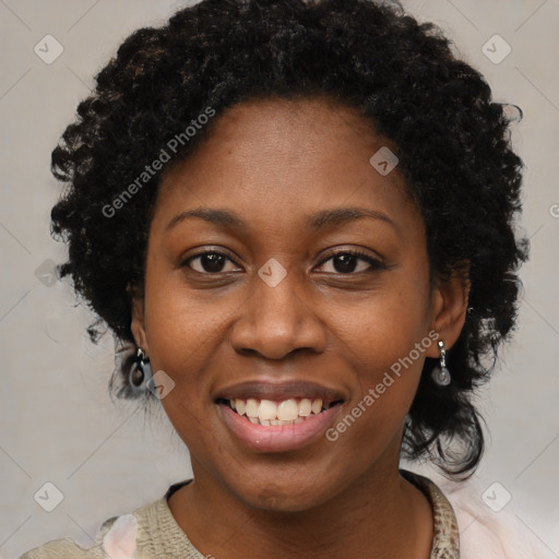 Joyful black adult female with short  brown hair and brown eyes