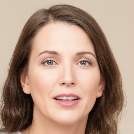 Joyful white young-adult female with medium  brown hair and green eyes