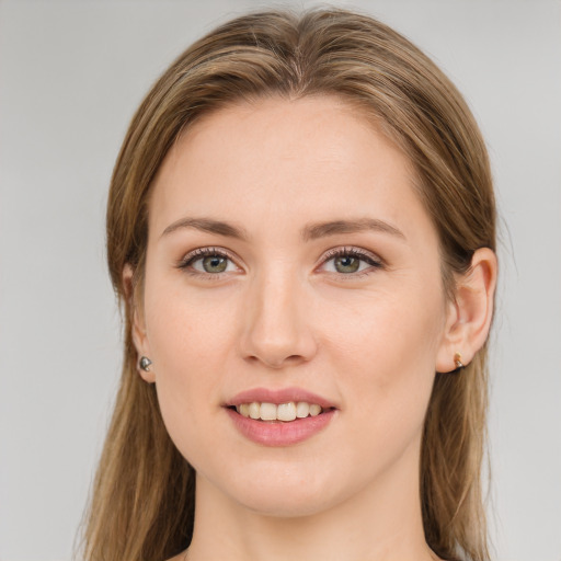 Joyful white young-adult female with long  brown hair and green eyes