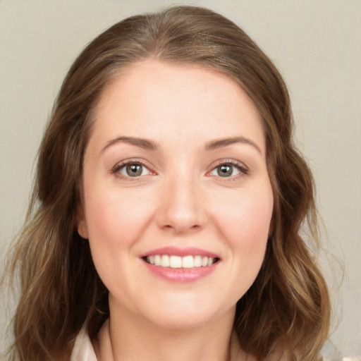 Joyful white young-adult female with long  brown hair and green eyes