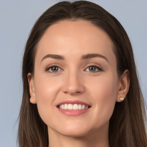 Joyful white young-adult female with long  brown hair and grey eyes